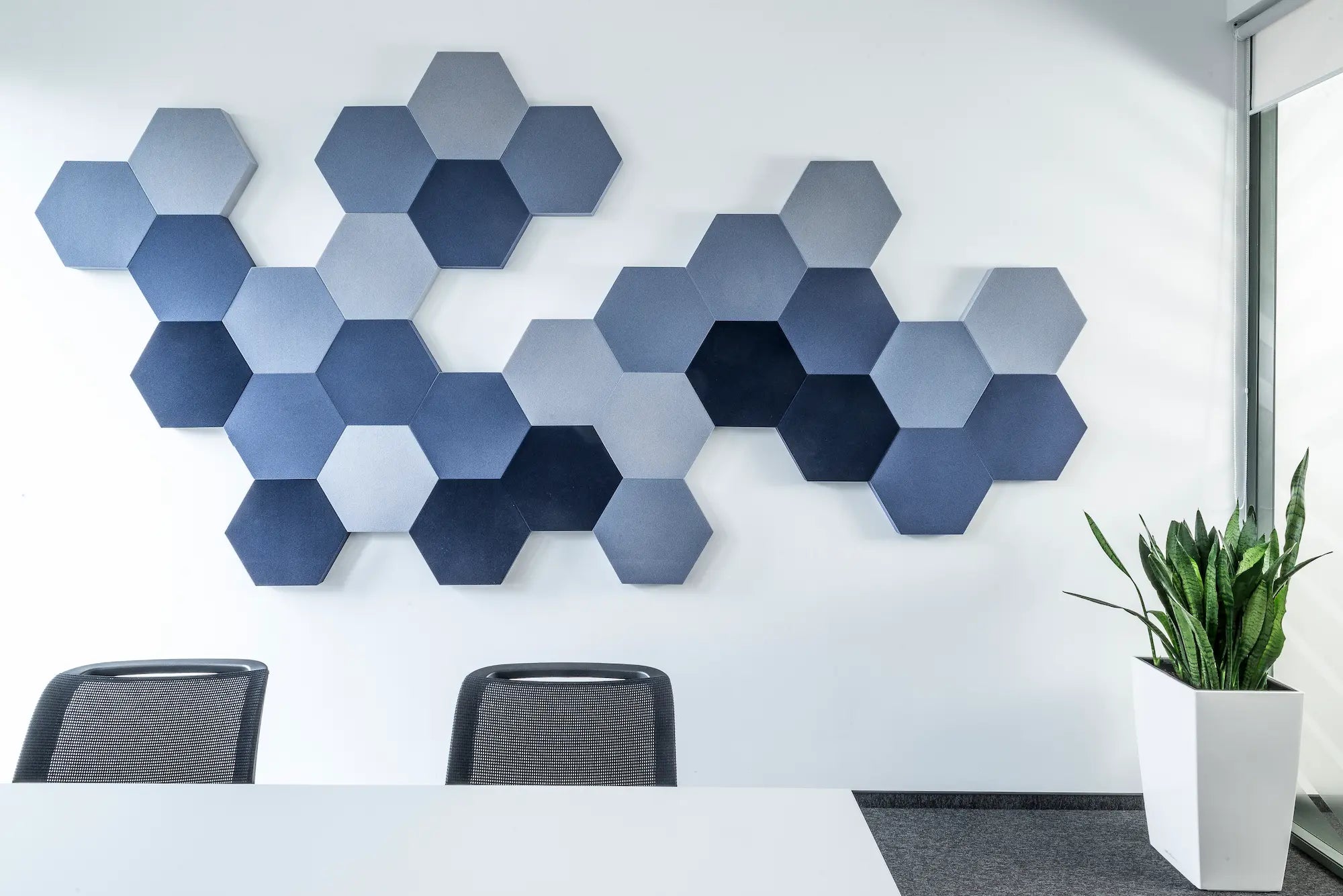 Hexagonal acoustic panels on the office wall